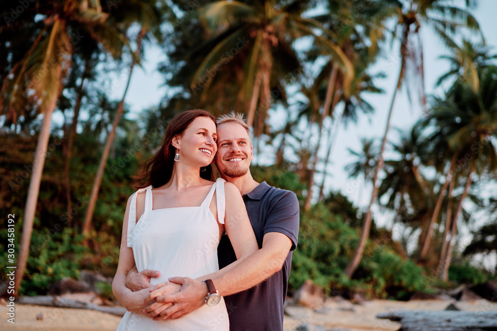 Love and romance. Honeymoon on the sea shore. Beautiful loving couple embracing on the tropical beach. Love and romance. Honeymoon on the sea shore. Beautiful loving couple embracing on the tropical beach.