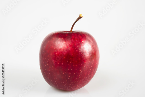 Fresh colorful apple over gray background - clean fresh fruit background concept