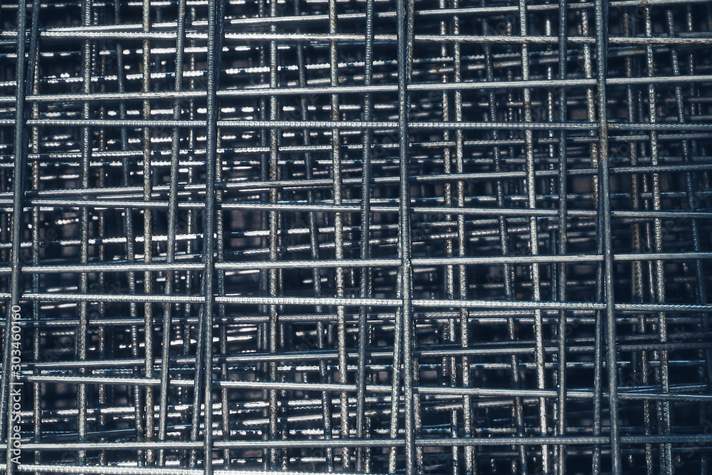 Steel bar for building materials. Wire reinforcing mesh. Industrial grunge background. Steel bar for building materials. Wire reinforcing mesh. Industrial grunge background.