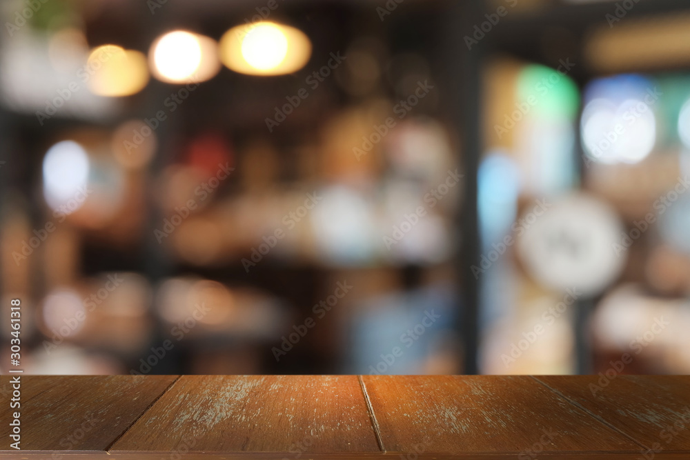 Empty dark wooden table in front of abstract blurred bokeh background of restaurant . can be used for display or montage your products.Mock up for space.