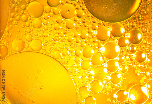 Air bubbles in the water background.Abstract oxygen bubbles in the sea.Circle foamy air in the ocean.Water bubbles isolate on gold background.