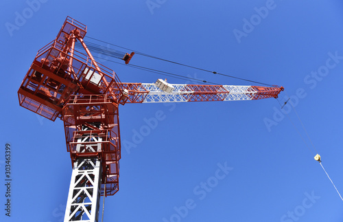 Construction machinery: A tower crane looking up from below. At the high-rise apartment site. photo