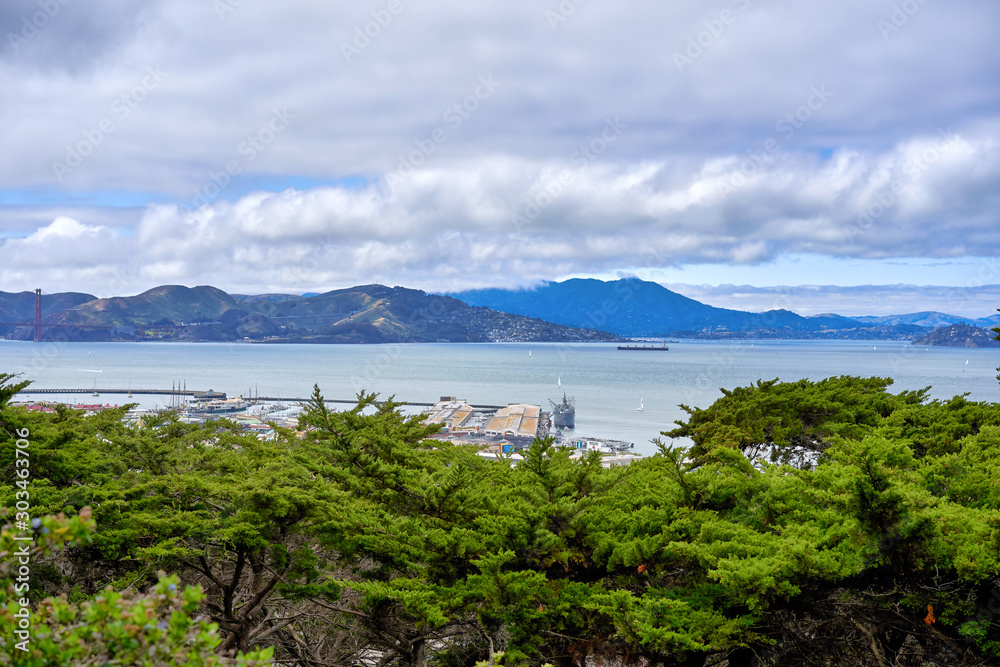 San Francisco, CA, USA - May 15, 2018: View of the San Francisco Bay from the observation deck of Columbus. Hilly terrain, cloudy, Golden Gate Bridge visible