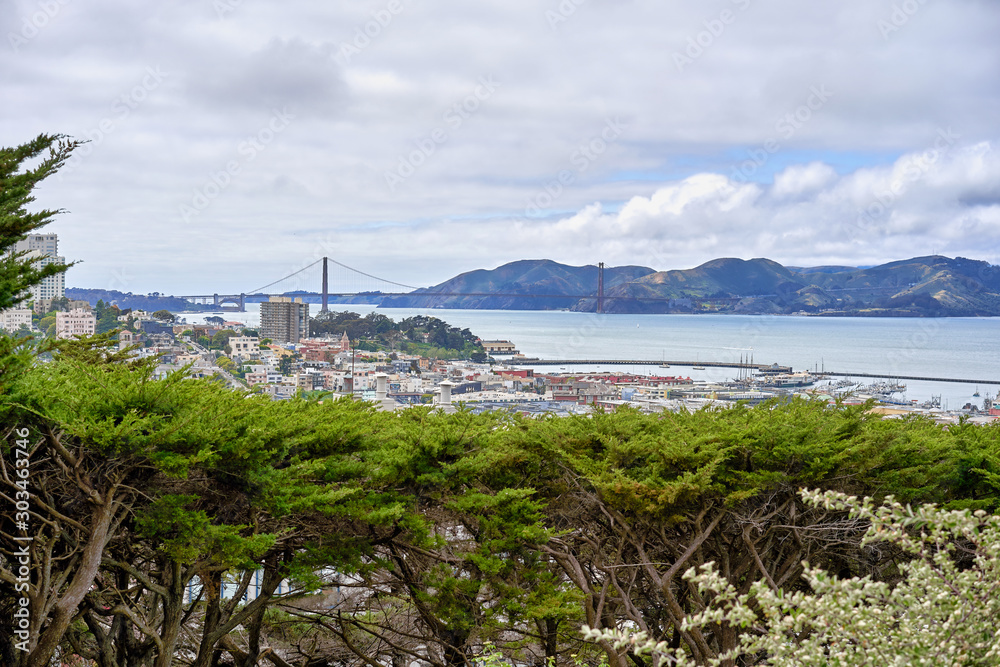 San Francisco, CA, USA - May 15, 2018: View of the San Francisco Bay from the observation deck of Columbus. Hilly terrain, cloudy, Golden Gate Bridge visible