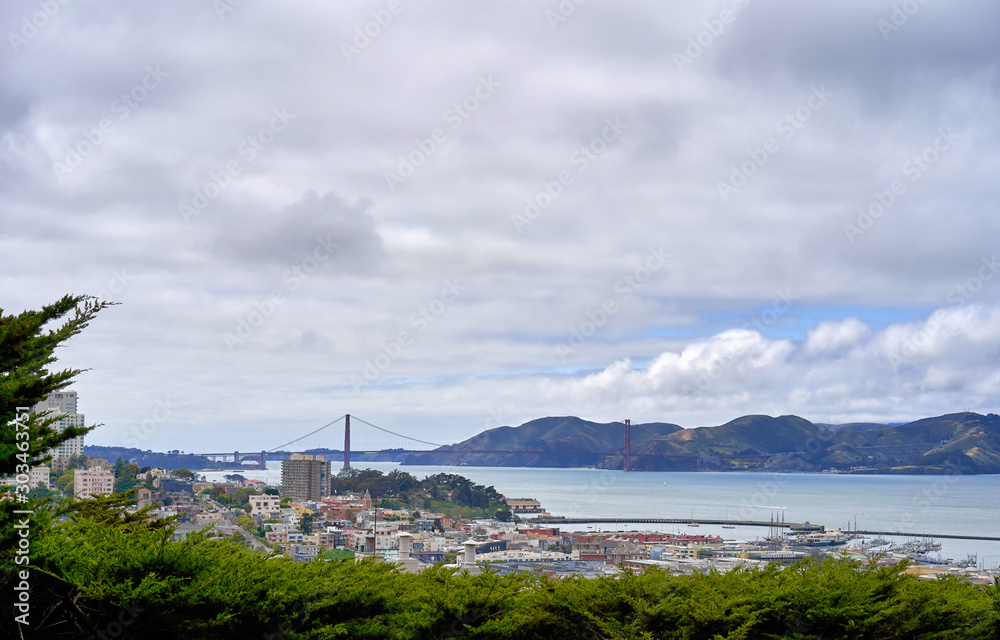 San Francisco, CA, USA - May 15, 2018: View of the San Francisco Bay from the observation deck of Columbus. Hilly terrain, cloudy, Golden Gate Bridge visible