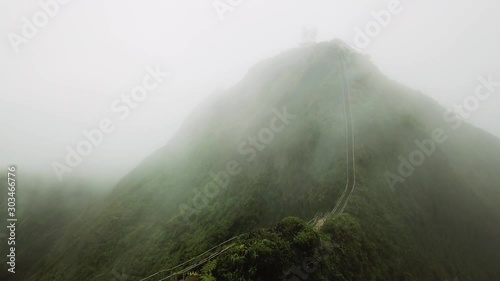 Clouds moving over the Haiku Stairs trail, also known as Stairway to Heaven. Aerial Shot, Oahu, Hawaii. photo