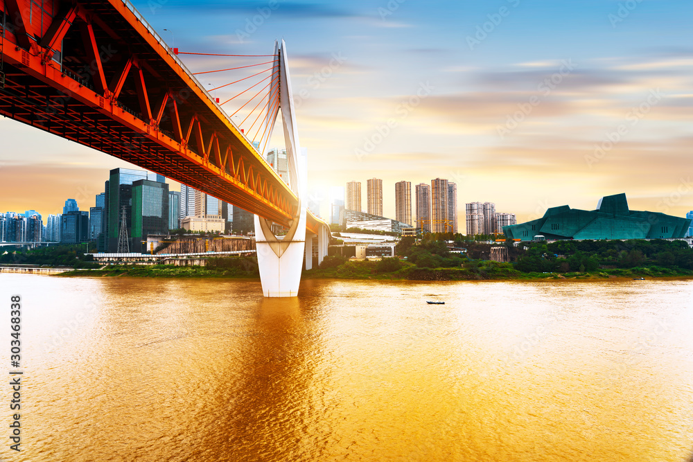 cityscape and skyline of downtown near water of chongqing at sunset