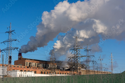 Thermal power plant in severe frost. Thick grey smoke comes from the chimney. Pollution of nature © Melena-Nsk
