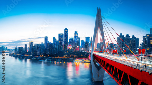 cityscape and skyline of downtown near water of chongqing at sunset photo