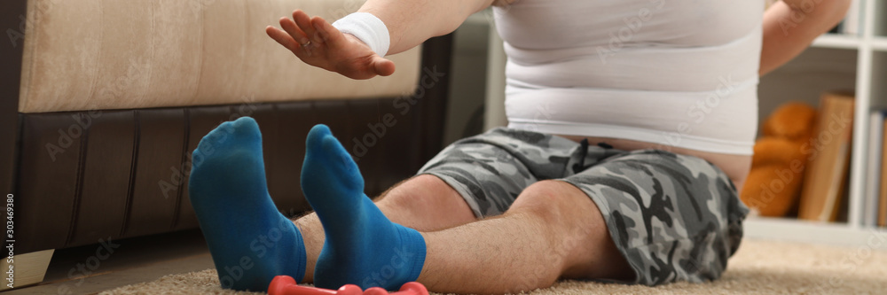 Young attractive fitness man lies on a fat mat with