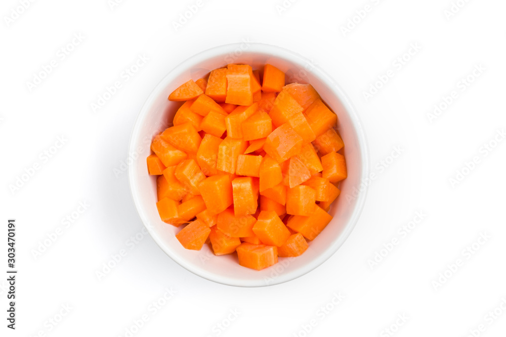 Top view (flat lay) of chopped carrots in a white ceramic bowl on white background with clipping path. Top view (flat lay) of chopped carrots in a white ceramic bowl on white background with clipping path.
