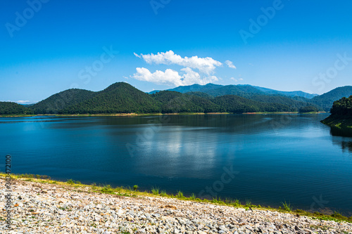 Dam water release with blue sky.