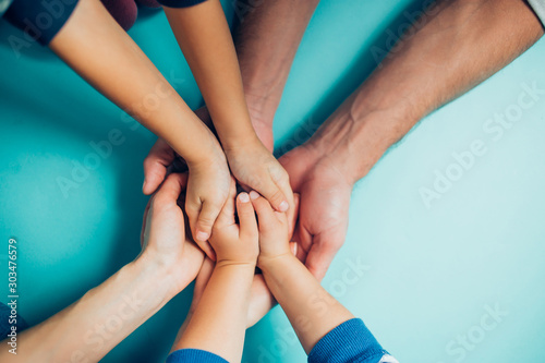 family hands on blue background