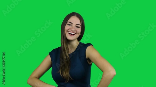 Sexy attractive girl laughing and smiling in front of a green screen photo