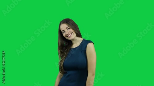 Happy smiling girl in front of a green screen photo