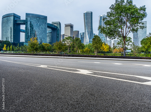 empty asphalt road front of modern buildings. © hallojulie