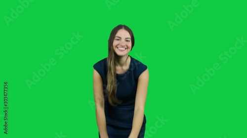 Sexy attractive girl laughing and smiling in front of a green screen photo
