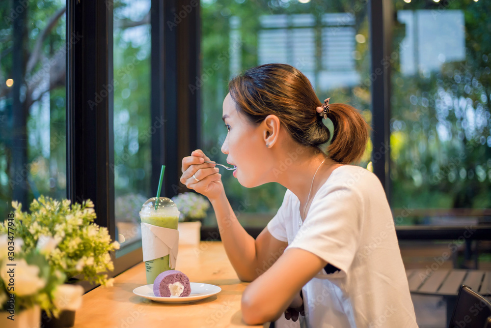 Closeup of woman eating chocolate cake in a cafe Closeup of woman eating chocolate cake in a cafe
