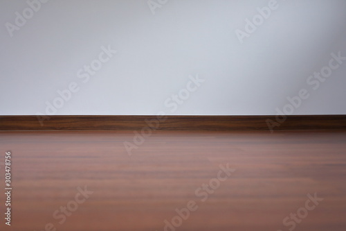 white wall and wood laminate floor in empty room