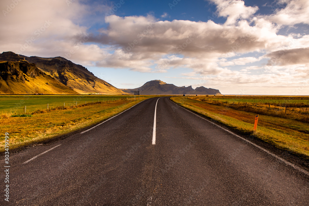 Road through iceland landscape. Road travel concept. Car travel adventure. Beautiful landscape in Iceland.