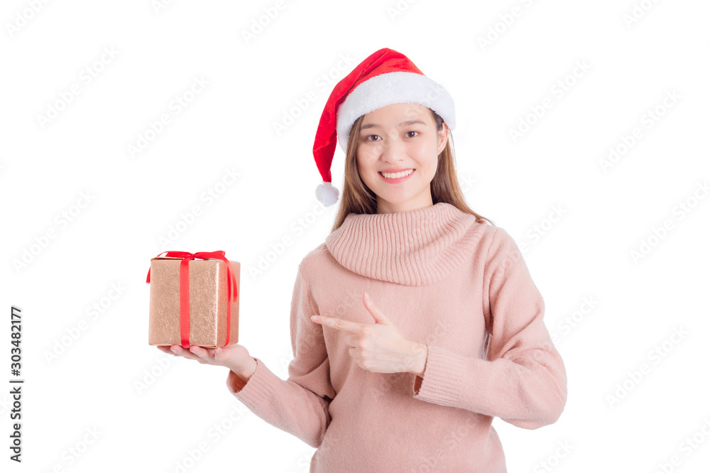Φωτογραφία Beautiful asian girl wearing santa claus hat holding christmas gift box and smiles isolated over white background