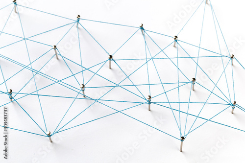 Communication  technology  network concept. Network with pinsA large grid of pins connected with string. Communication  technology  network concept. Network with pins