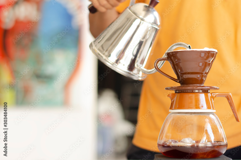 barista dripping coffee. Barista holds a hot water in pouring to coffee making. barista dripping coffee. Barista holds a hot water in pouring to coffee making.