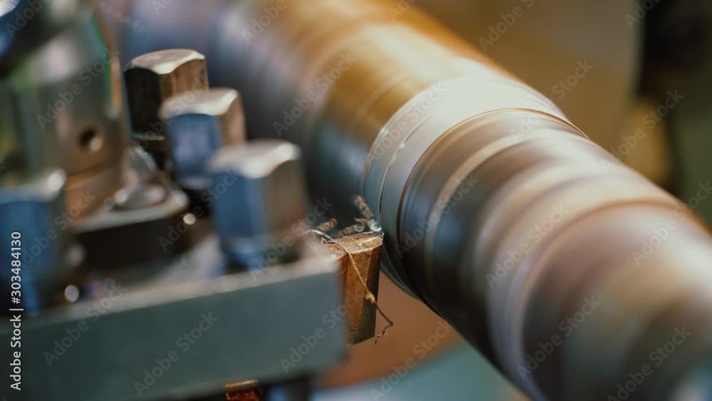 Lathe working. Metal tube cutting. Close-up of cutter which is shaving metal at workshop