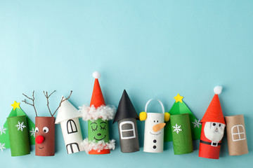 Paper toy Santa, Snowman, Grinch for Xmas party. Easy crafts for kids on blue background, copy space, die creative idea from toilet tube roll, recycle reuse eco concept
