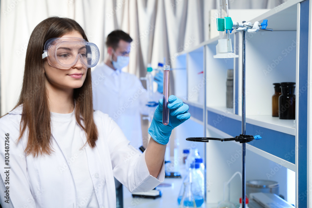 Scientist holding test tube with liquid indoors. Laboratory analysis Scientist holding test tube with liquid indoors. Laboratory analysis