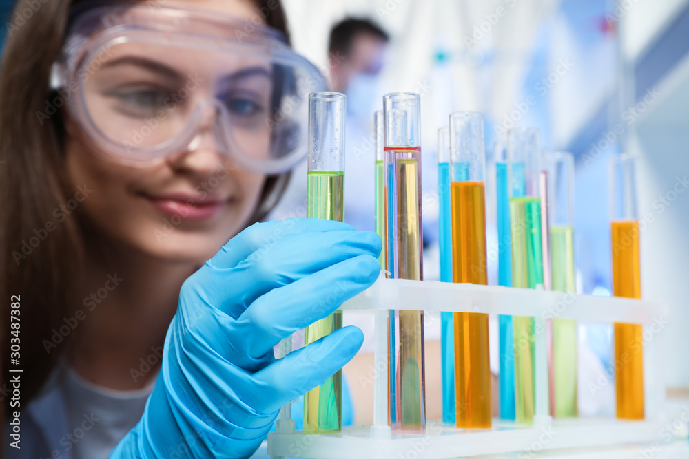 Scientist taking test tube from rack indoors. Laboratory analysis Scientist taking test tube from rack indoors. Laboratory analysis