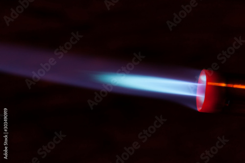 The blue bright light of a gas burner closeup. 