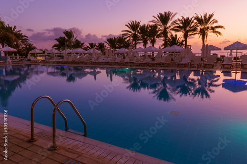 Swimming pool on Cyprus island at sunset