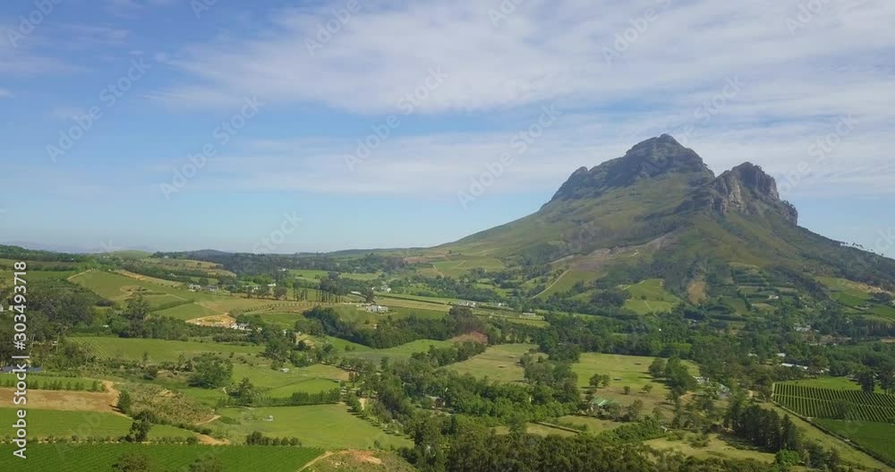 Wide shot of Simonsberg mountain with farmland below. Wide shot of Simonsberg mountain with farmland below.