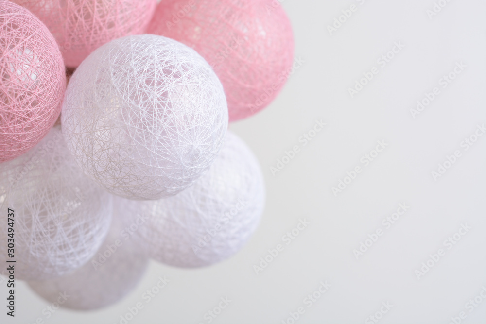 Garland from pink and white balls on the white background Garland from pink and white balls on the white background
