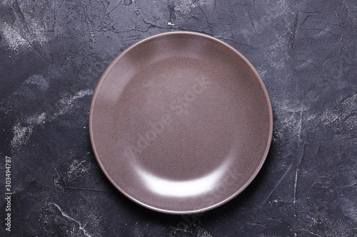Empty plate on dark background. Retro toned. Top view with copy space