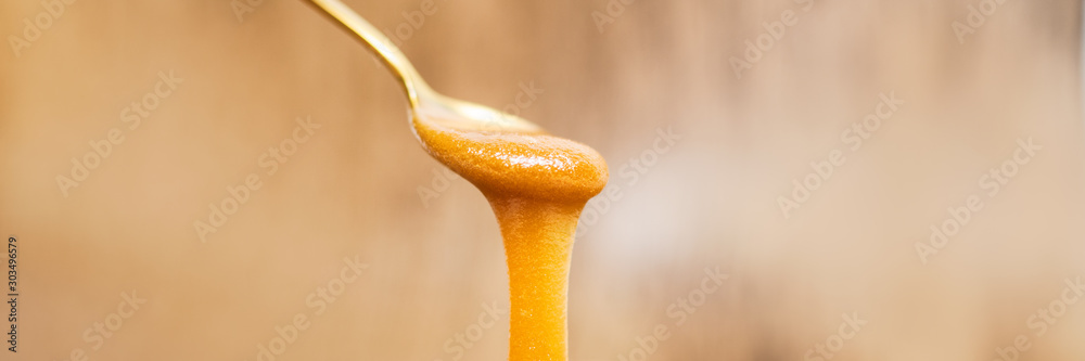 Φωτογραφία Manuka honey dripping from golden spoon healthy natural superfood on wooden panoramic banner background