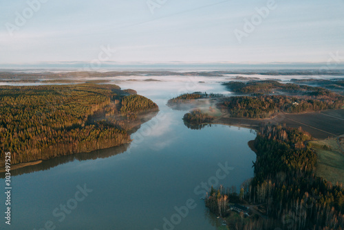 Fototapeta Naklejka Na Ścianę i Meble -  Beautiful landscape of a foggy lake. Aerial view at autumn lake landscape in Finland