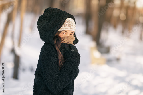 Cold winter protection Asian woman protecting skin covering nose and mouth with warm scarf - cold weather clothes accessories outdoor people lifestyle.