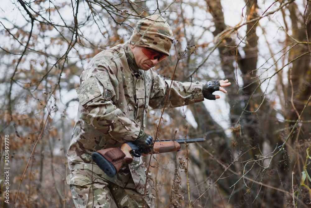 Hunting permit. Man brutal gamekeeper nature background. hunter spend leisure hunting. Hunter hold riffles. Focus and concentration of experienced hunter. Hunting and trapping seasons. Hunting permit. Man brutal gamekeeper nature background. hunter spend leisure hunting. Hunter hold riffles. Focus and concentration of experienced hunter. Hunting and trapping seasons.