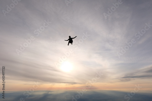 Skydiving. A solo skydiver is flying in the sky