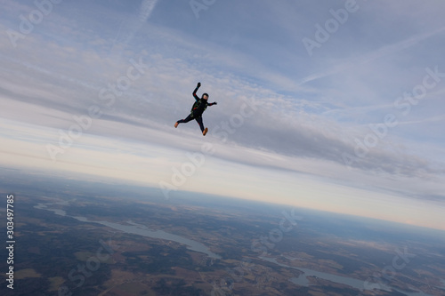 Skydiving. A solo skydiver is flying in the sky