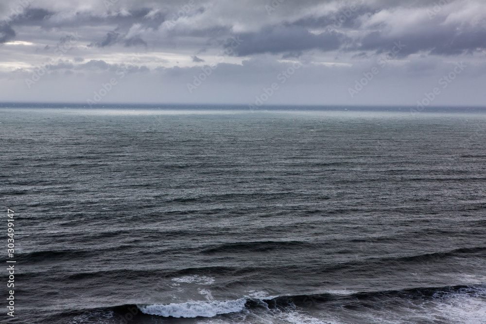 Beautiful coast of the Atlantic ocean with mountains. Waves of the North Atlantic ocean crashing against the beach in iceland after a storm. Beautiful coast of the Atlantic ocean with mountains. Waves of the North Atlantic ocean crashing against the beach in iceland after a storm.