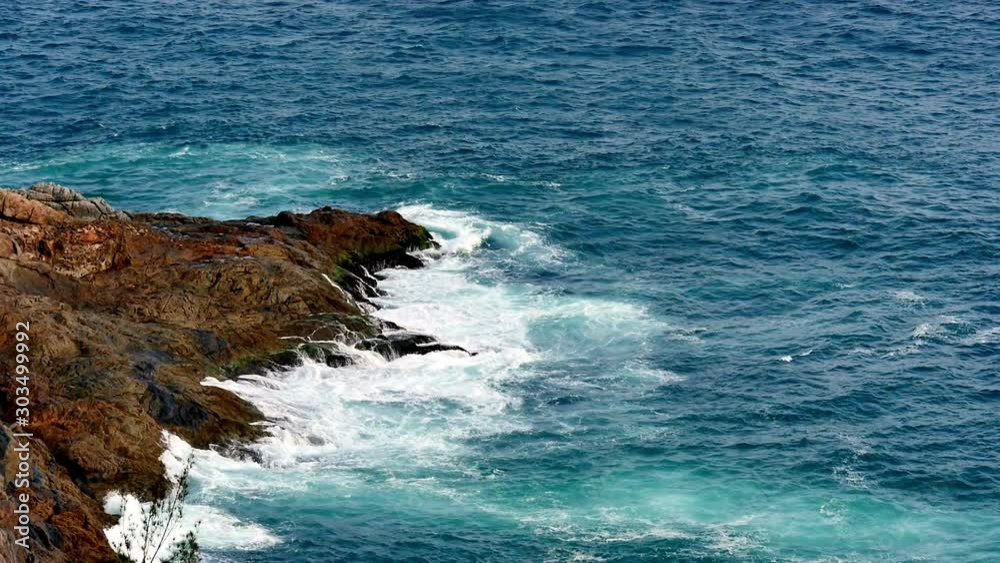 Blue ocean water splashed against a rocky point during high tide in Brazil Blue ocean water splashed against a rocky point during high tide in Brazil