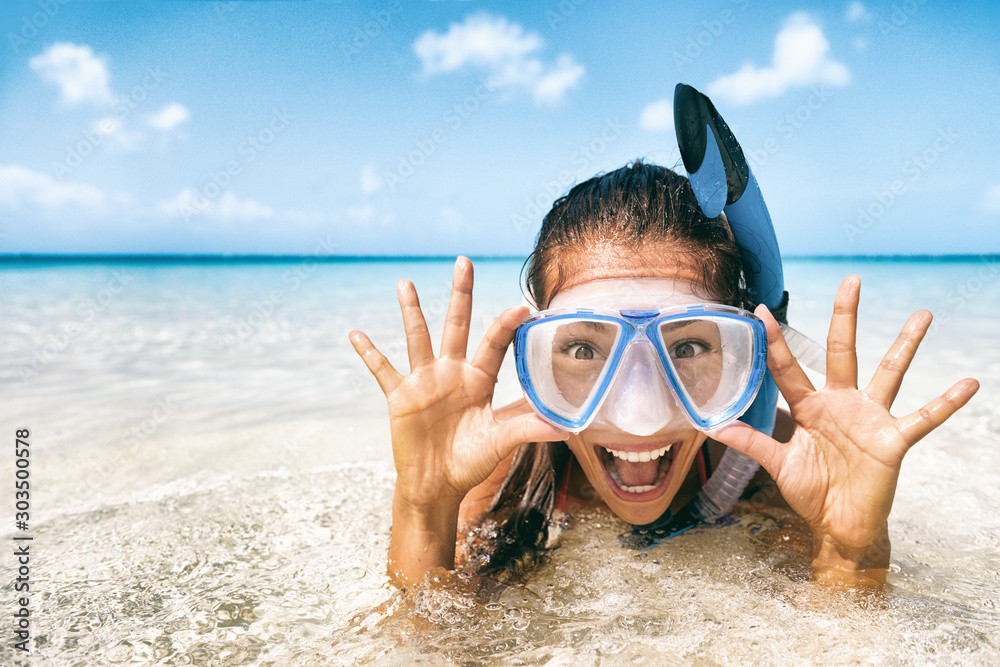 Beach vacation tourist Asian girl swimming in scuba mask making a goofy face. Snorkel fun woman on tropical travel holidays.