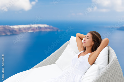 Fotografie, Obraz Luxury hotel wellness Asian woman sleeping on outdoor lounger relaxing