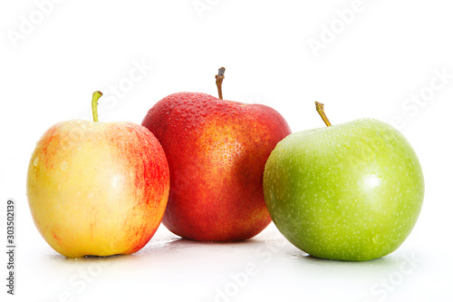 Delicious appetizing beautiful fresh green and two red apples isolated on a white background.