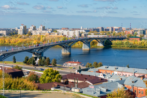 NIZHNY NOVGOROD, RUSSIA - SEPTEMBER 28, 2019: View of the city, the Kanavinsky district , the Kanavinsky bridge over the Oka River from the embankment of Fedorovsky in the sunny autumn day