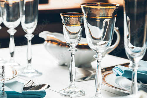 Close up shot of table setting for fine dining with cutlery and glassware