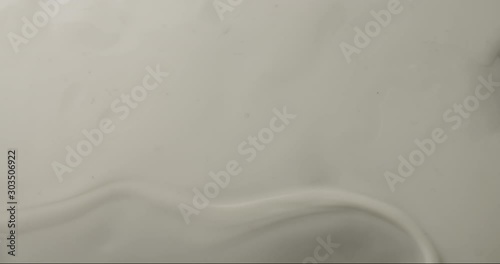 Non newtonian fluid starts to form waves at the right side of the frame. Top shot of a non newtonian fluid with movement. photo